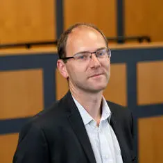 staff profile photo for senior lecturer Martin Salisbury in the moot courtroom