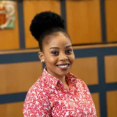Omotalani staff profile picture in the moot court rooms