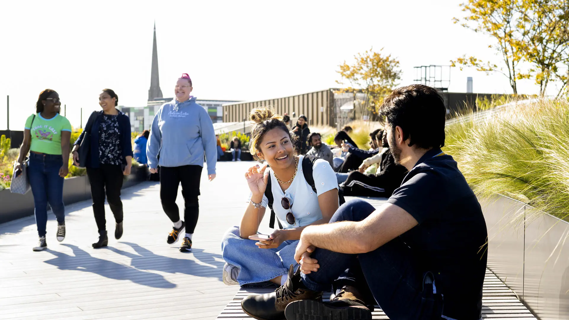 groups of international students either sat or walking around on the student centre roof terrace