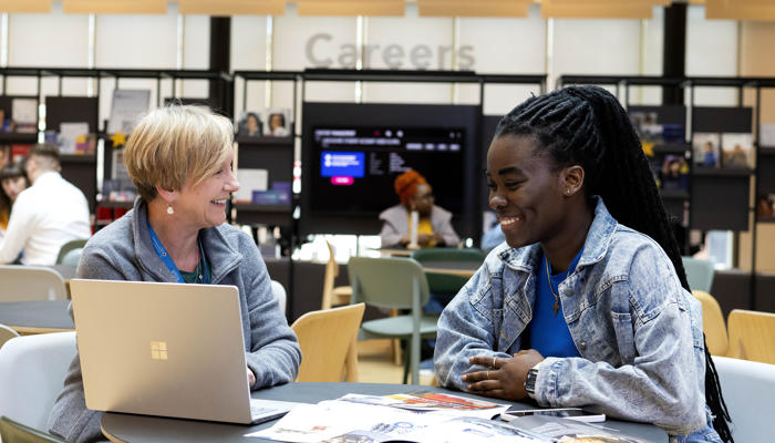 A careers adviser giving support to a student