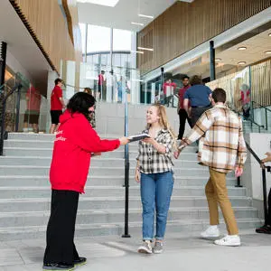Student being greeted at an open day in the Student Centre