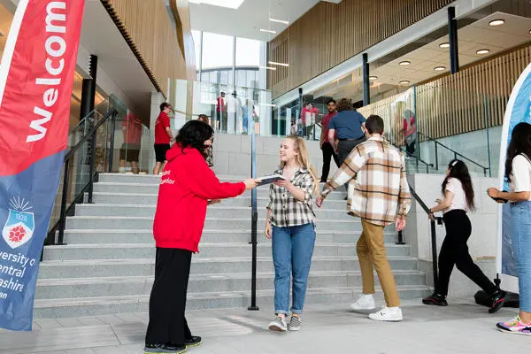 Student being greeted at an open day in the Student Centre
