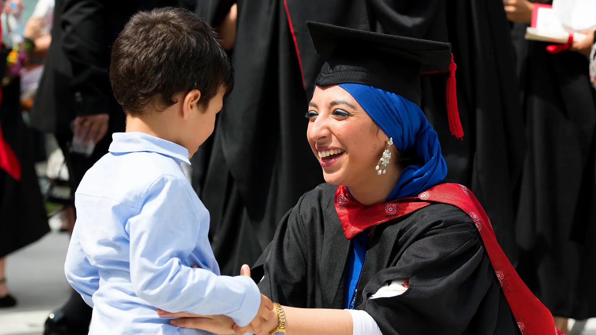 A mature student graduating from UCLan with her young child.