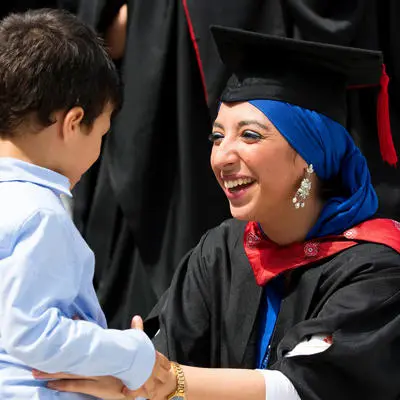 A mature student graduating from UCLan with her young child.