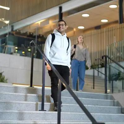 Student walking down the stairs in the Student Centre