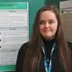 jessica geddes at a poster presentation smiling