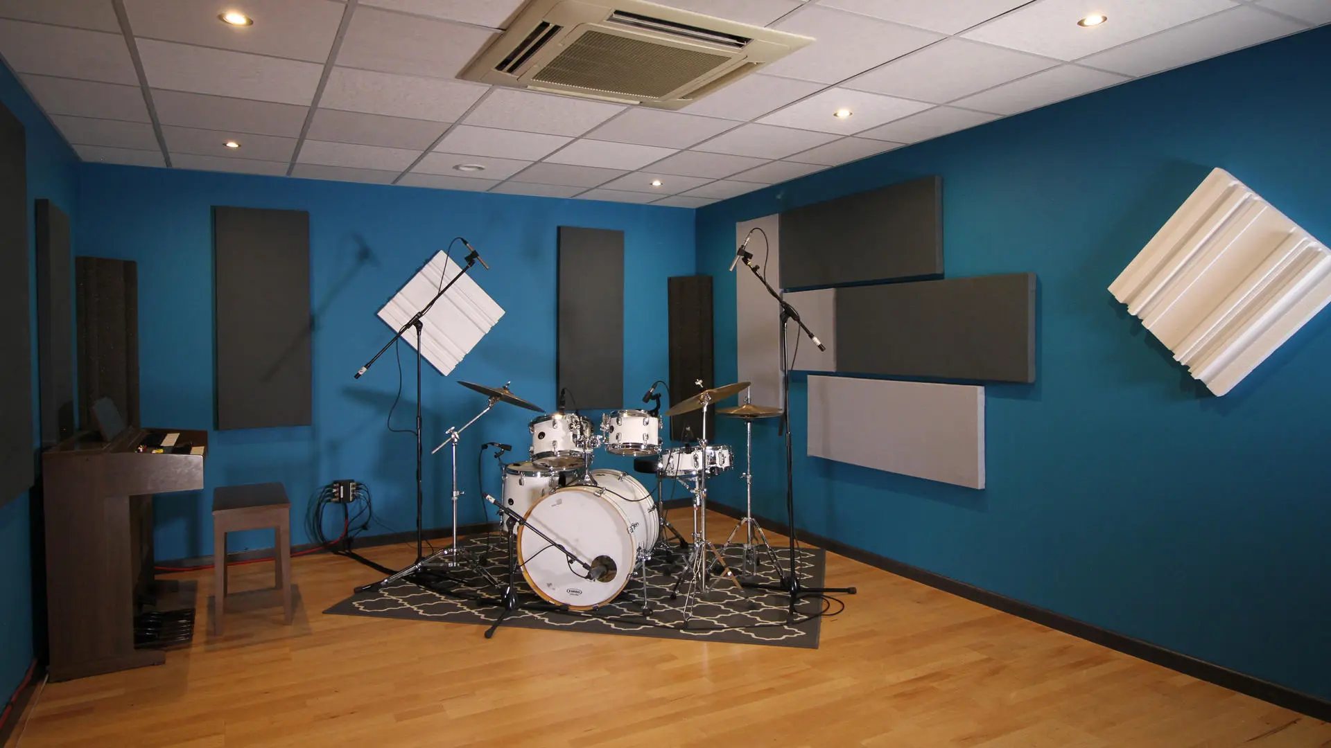 Recording room with drum kit and keyboard