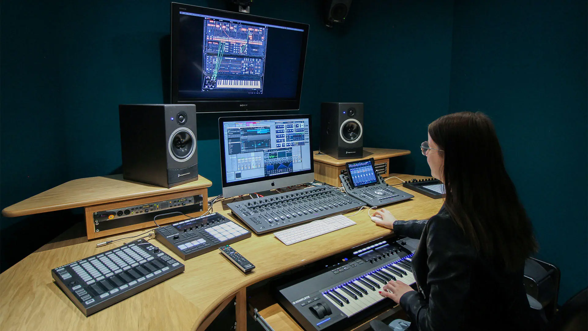 Student using equipment in recording studio