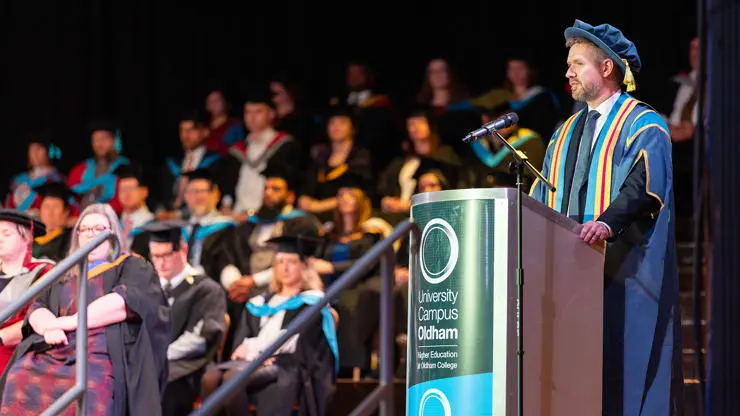 Simon Jordan, College Principle, delivers a speech to 2023 graduates