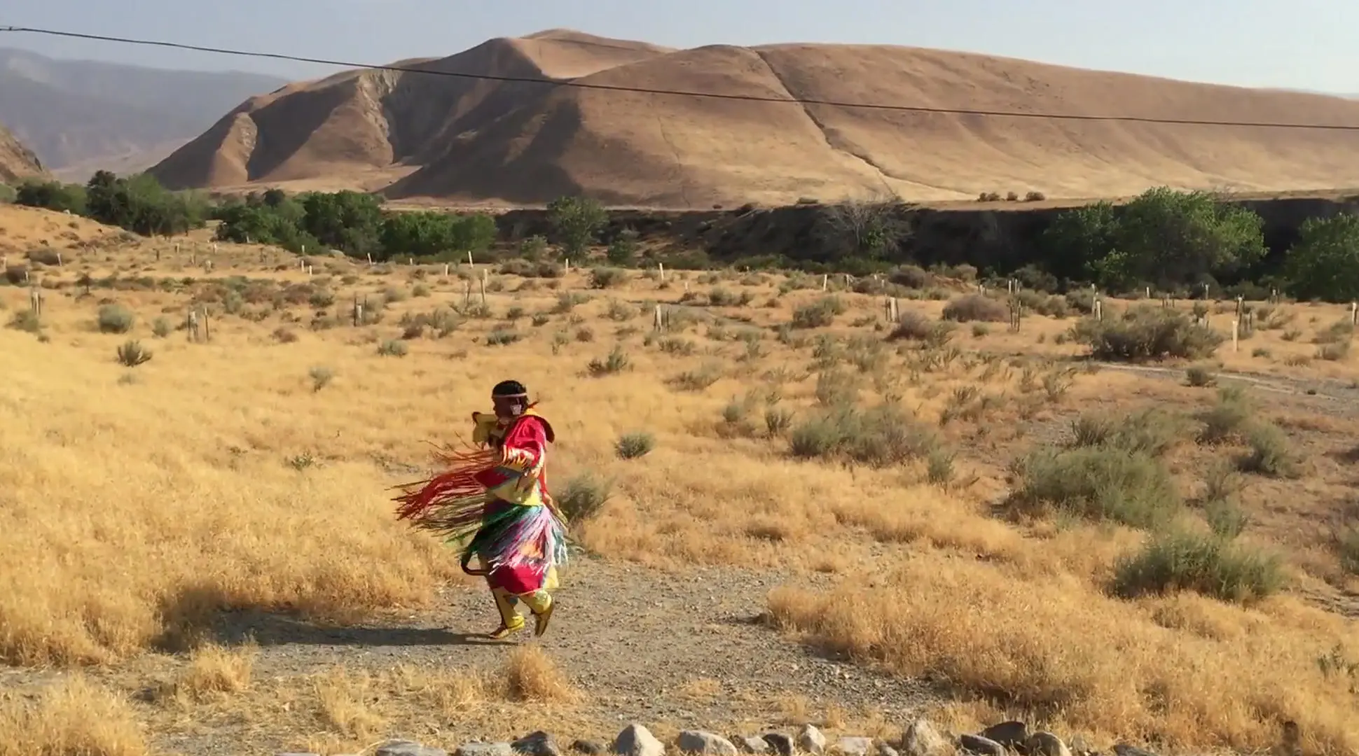 tribe member dancing in the desert
