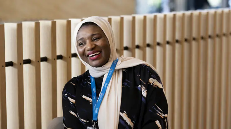 member of staff halima kure smiling in the student centre