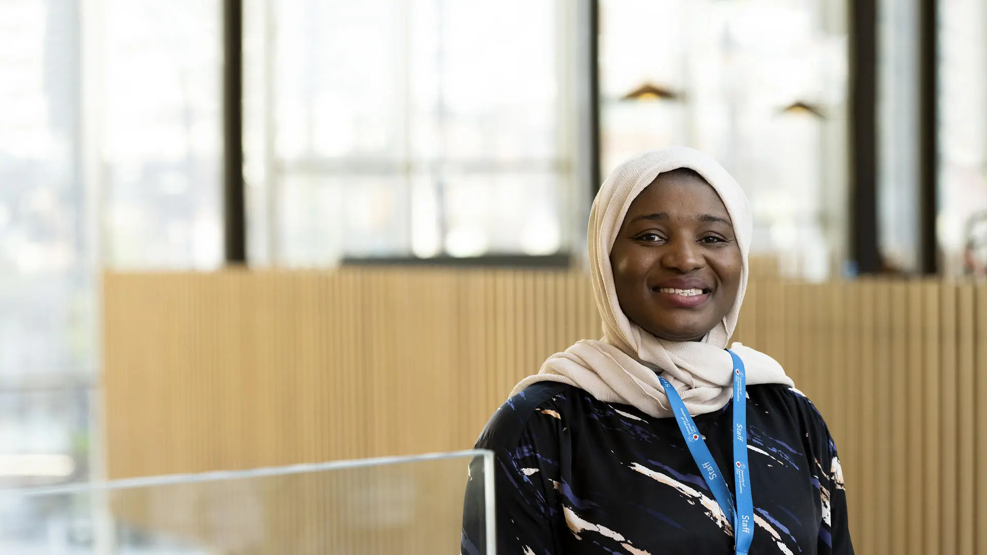 member of staff halima smiling in the student centre