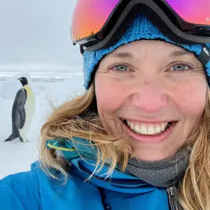Lucy Coulter outside in the snow taking a selfie with a penguin