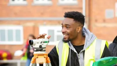 Student uses surveying equipment