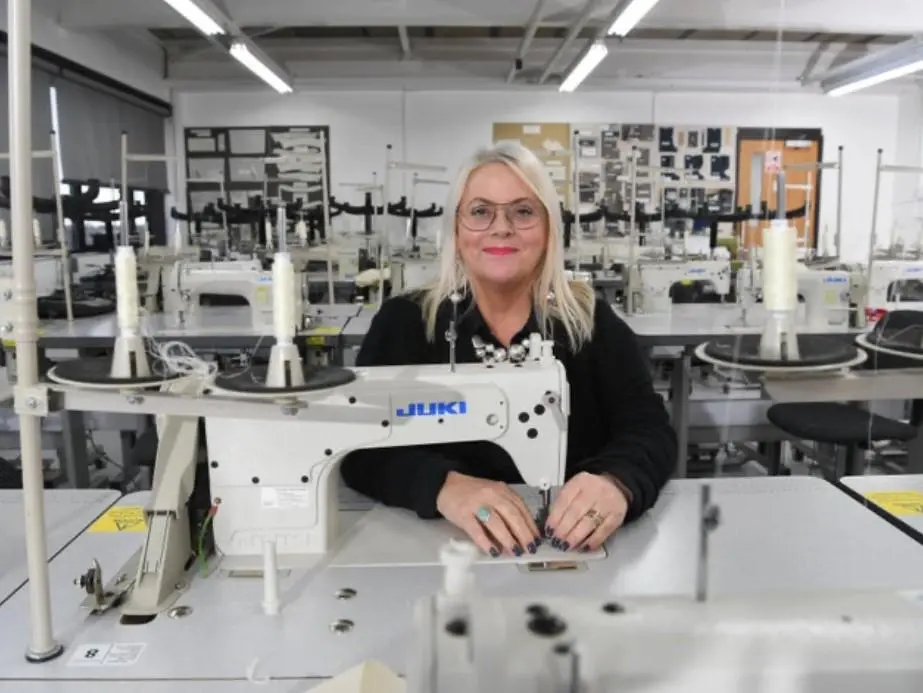 woman holding sewing machine