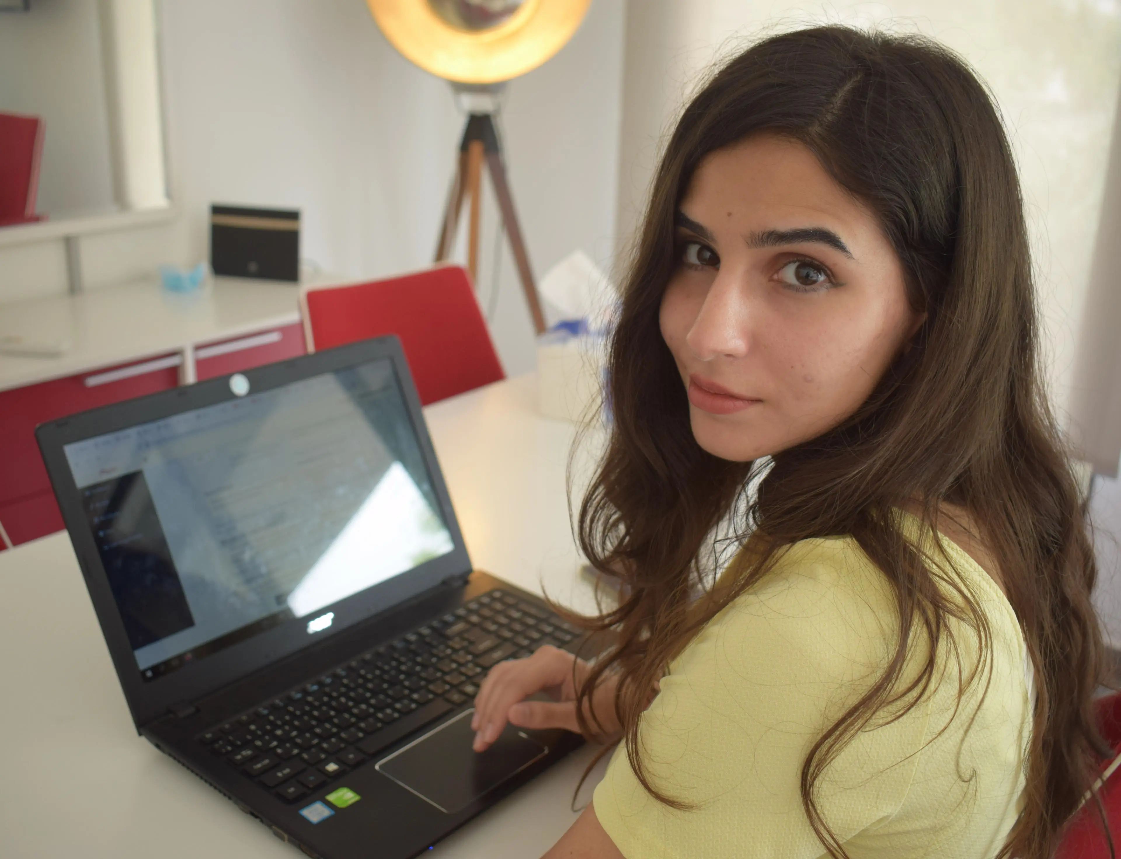 Rayne Merhi, LLM International Law and Security graduate, working on her laptop.