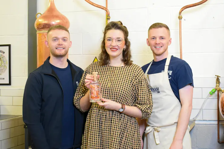 Ellis (left) with his business partner, Liam Stemson and fellow UCLan graduate, Georgia-Maia, who designed a special edition gin bottle label