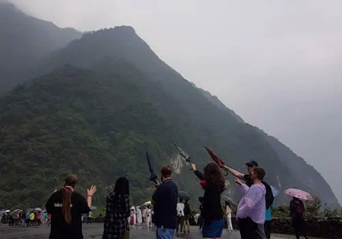 group of students stood by a misty mountain