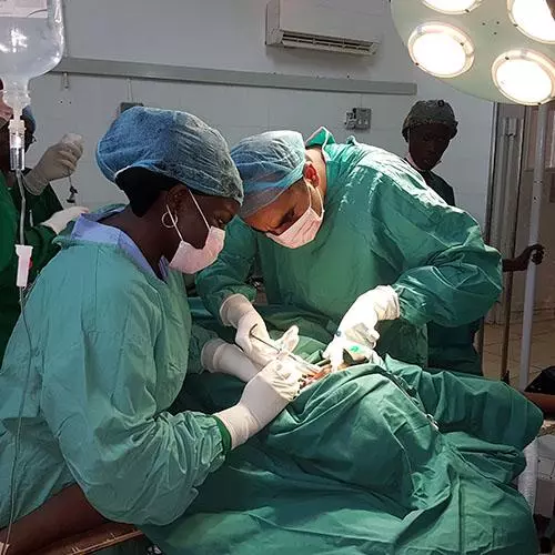 Usama and his colleague performing dental surgery.