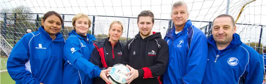 UCLan’s Cian McEvoy and Sarah Berry (centre) with the Sir Tom Finney Preston Soccer Centre team.