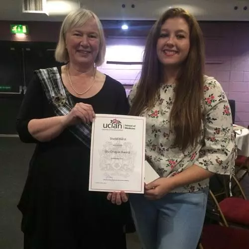 Shelbi Hurst (right) receives her certificate 