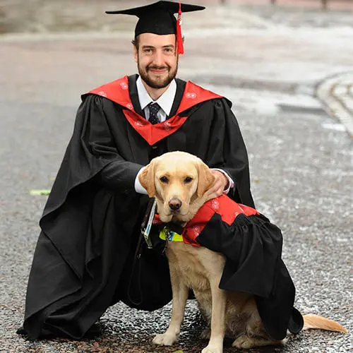 Graduate Robert Greggor and his guide dog, Angel