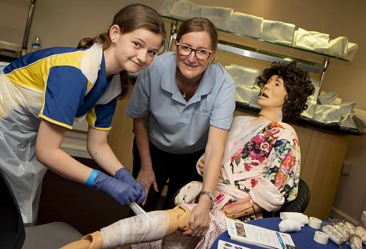 Lydia Mcleister,12, from Mount Carmel with Cadet Facilitator Lesley Nuttall bandaging Doris (mannequin)