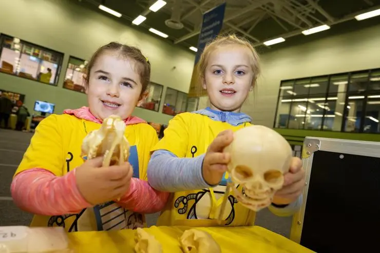 Holly and Lucy Gardner holding skulls