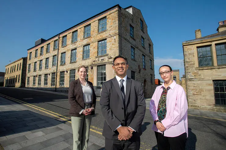(L-R) UCLan Burnley Campus strategic development lead Wendy Chester, Pro-Vice Chancellor and Provost of UCLan's Burnley campus, Professor Ebrahim Adia and UCLan Students’ Union President Zuleikha  Chikh outside of Sandygate Mill.