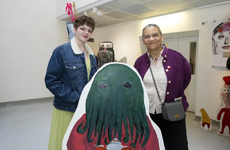 Minnie, 13 from Lancaster Girls’ Grammar School, shows Lubaina her large-scale cut out painting.