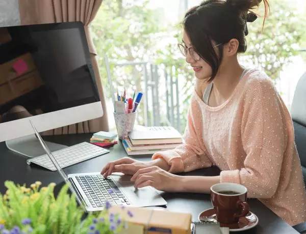  A woman pictured working from home at a computer 