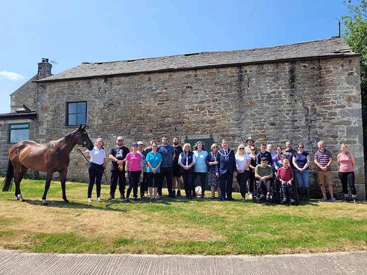 Volunteers from UCLan's College for Military Veterans and Emergency Services at The British Thoroughbred Retraining Centre.