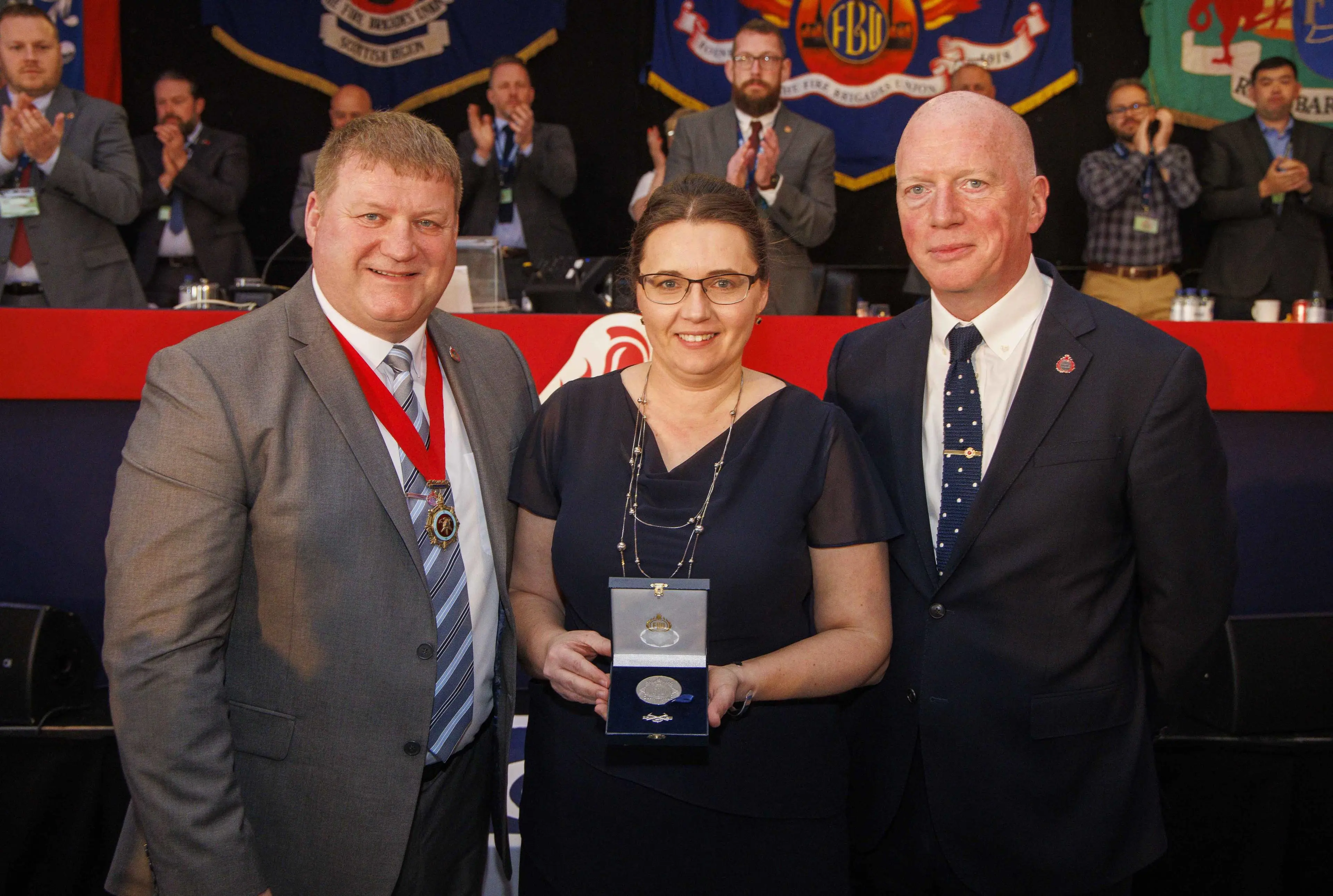 Professor Anna Stec is presented with her FBU Solidarity Medal by FBU President Ian Murray (left) and FBU General Secretary Matt Wrack (right).