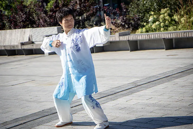 UCLan Confucius Institute Director Feixia performs Qigong movements.