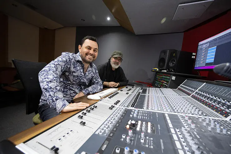UCLan MA Music Industry Management and Promotion student Paul Wolski (left) with Anthony King, who worked on the song’s orchestral arrangements, piano, keyboards, organs and bass, at a mixing desk in UCLan’s Media Factory.