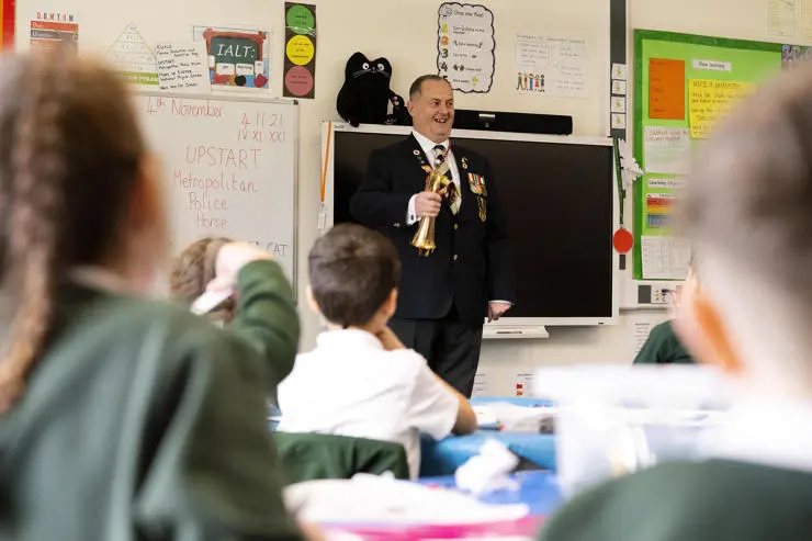 Darryl Cartwright, formerly of the King’s Royal Hussars, plays the bugle for Weeton Primary pupils. 