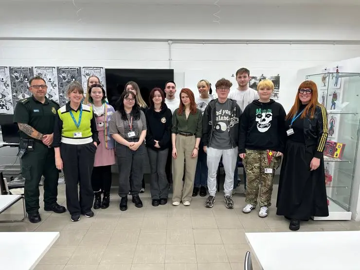 NWAS Operations Manager Craig Davies (far left) thanked UCLan illustration students (central), UCLan Course Leader, Maria Stuart (second from left) and UCLan Lecturer Rachelle Panagarry for their efforts in raising awareness of the importance of speaking openly about mental health