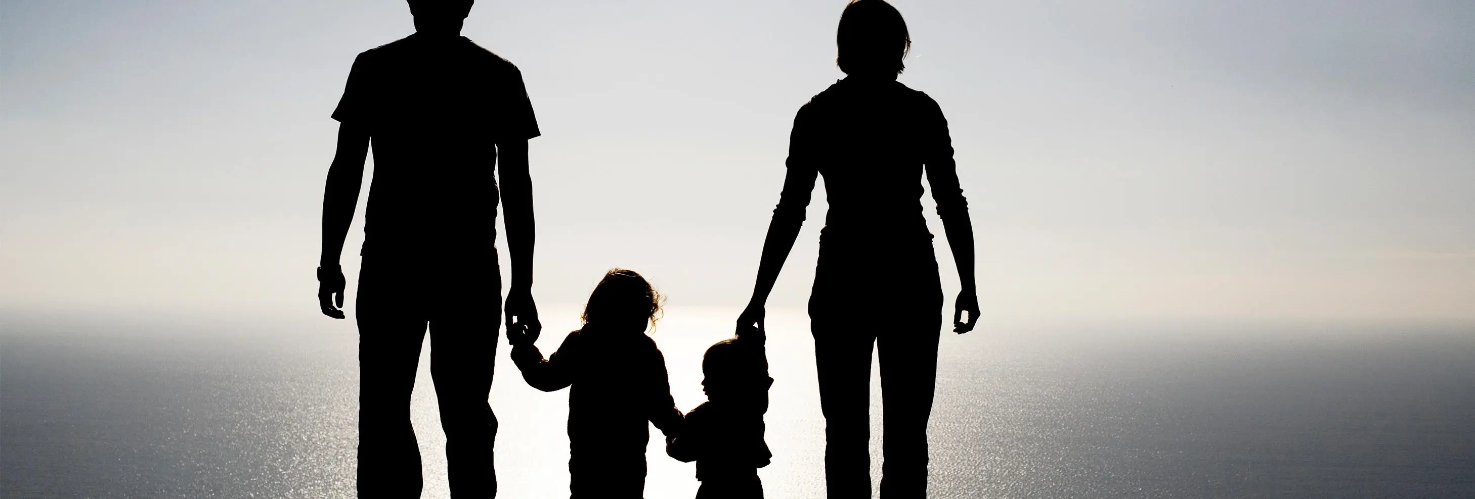 Family silhouette - parents and two young children