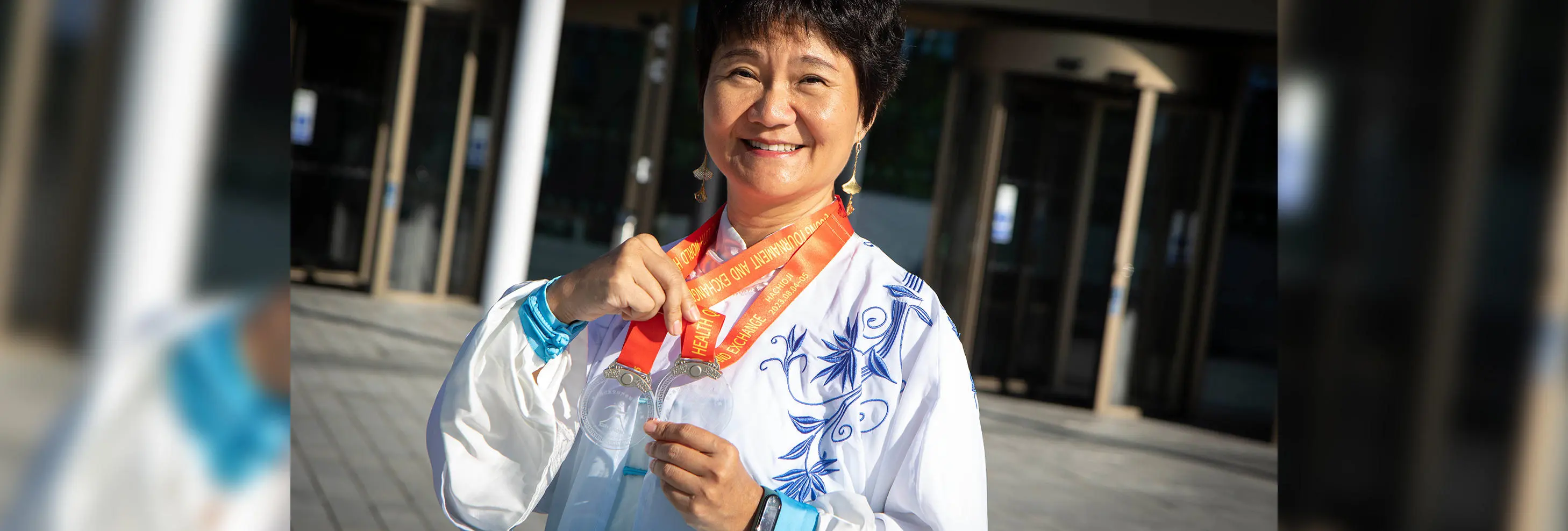 UCLan Confucius Institute Director Feixia with her two silver medals from the 10th World Health Qigong Tournament and Exchange in Tokyo.