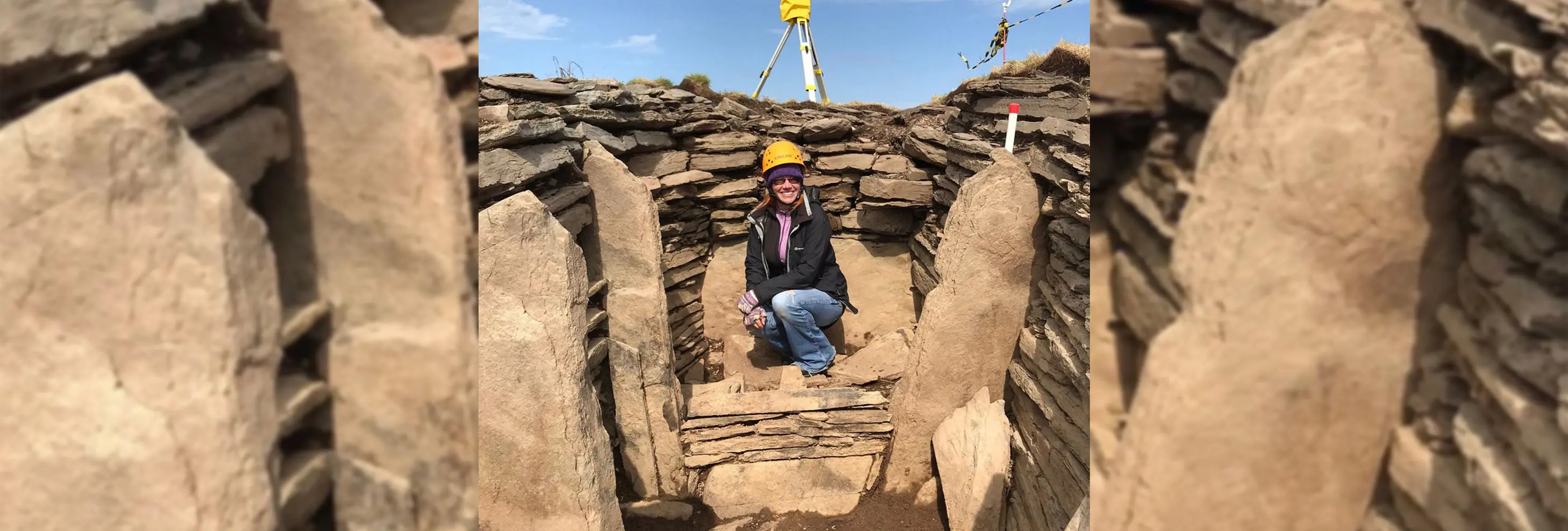 professor vicki cummings surrounded by boulders on an archaeological dig