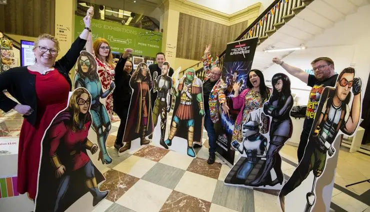 The seven UCLan academics with their cardboard cut out superhero characters.