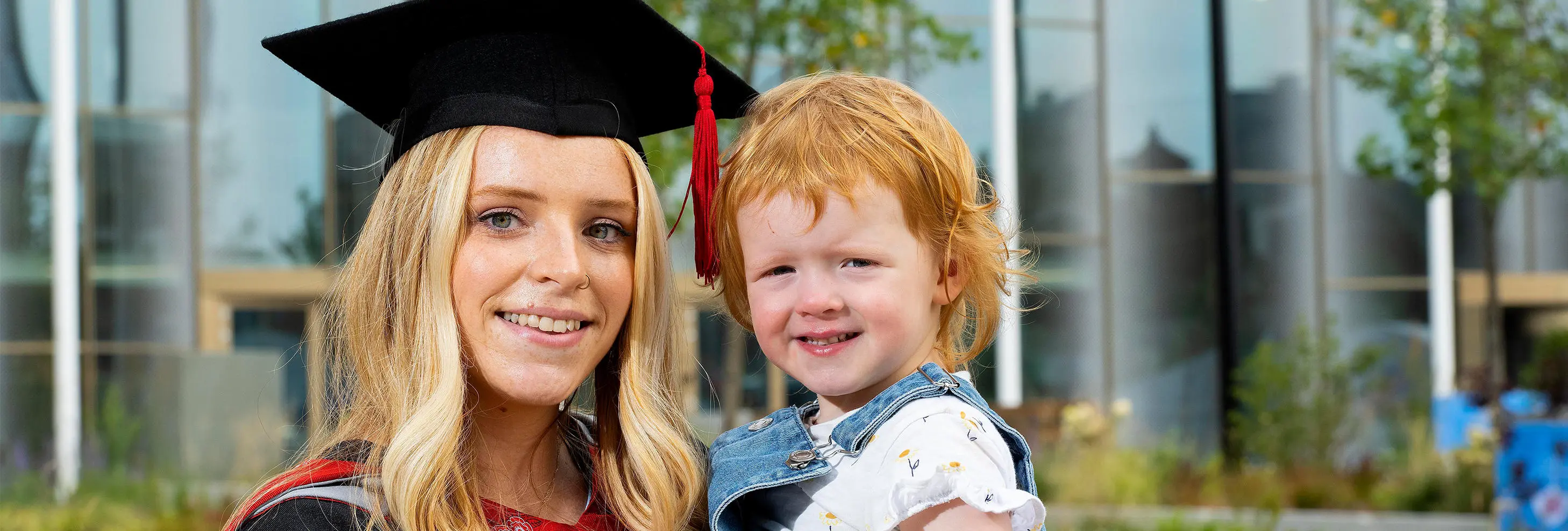 Stacey Wilson celebrates her graduation with her young daughter Scarlett