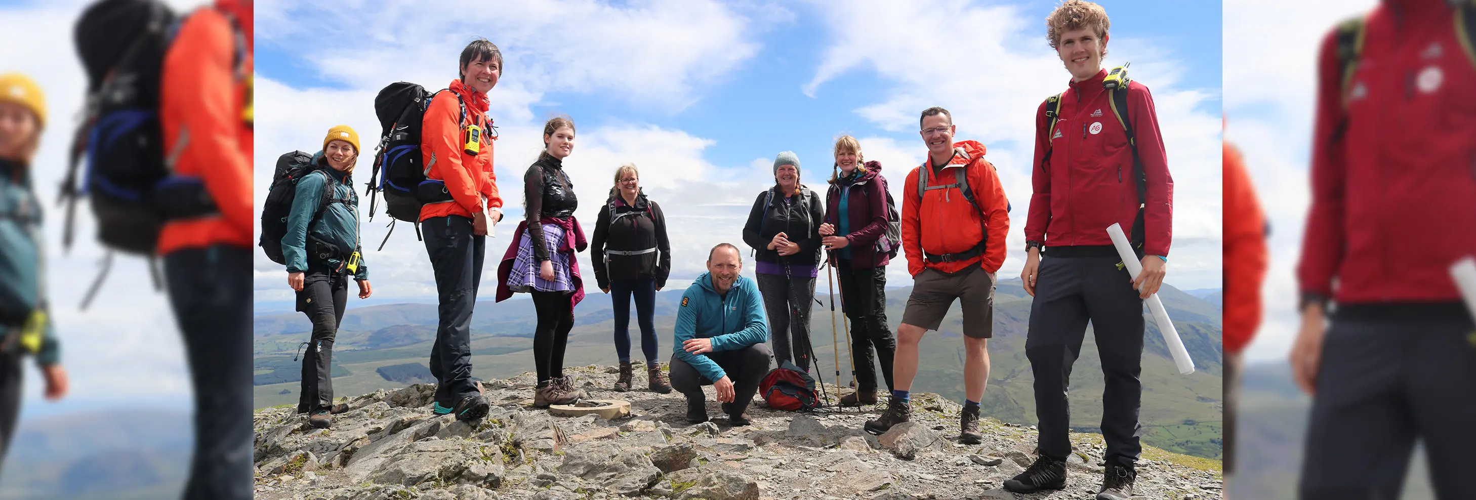 Mind over Mountains out founders (Chris Spray, centre kneeled and Alex Staniforth, far right) with a group of walkers in the Lake District