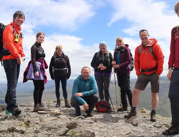 Mind over Mountains out founders (Chris Spray, centre kneeled and Alex Staniforth, far right) with a group of walkers in the Lake District