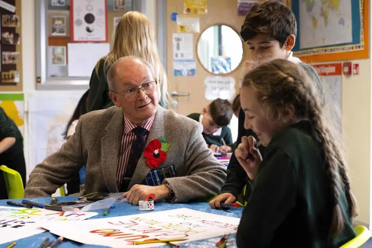 •Colonel David Waters, President of Preston and District Veterans Council, speaks to pupils.