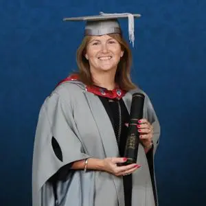 Honorary Fellow Alison Robinson holding a scroll