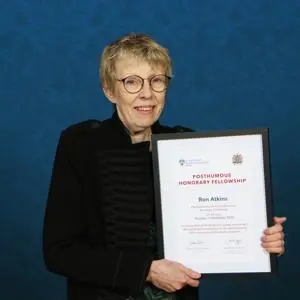 Liz Atkins holding a framed certificate