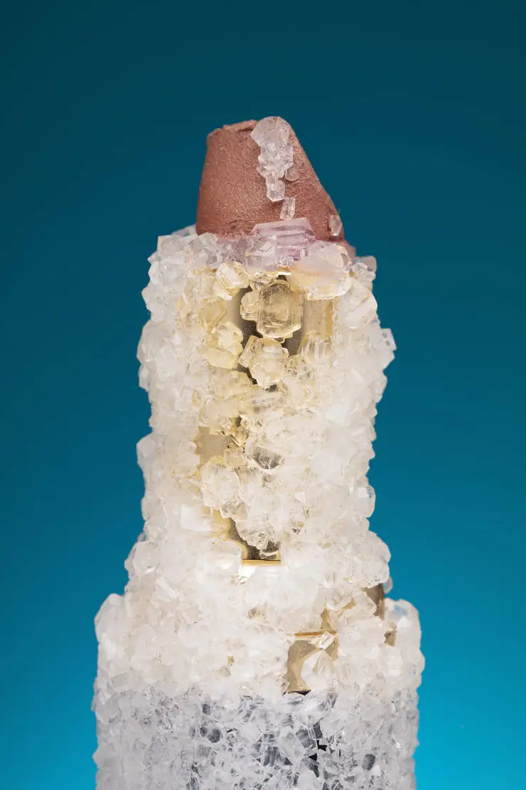 A close up of the crystals growing on a lipstick