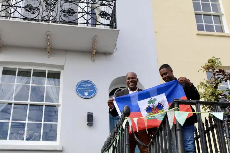 Michelet Romulus and Wilford Marous, Vice-President and President of the Haitian Chamber of Commerce in Great Britain, unveiling the plaque at 5 Exmouth Place