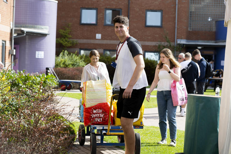 Students moving possessions into their accommodation